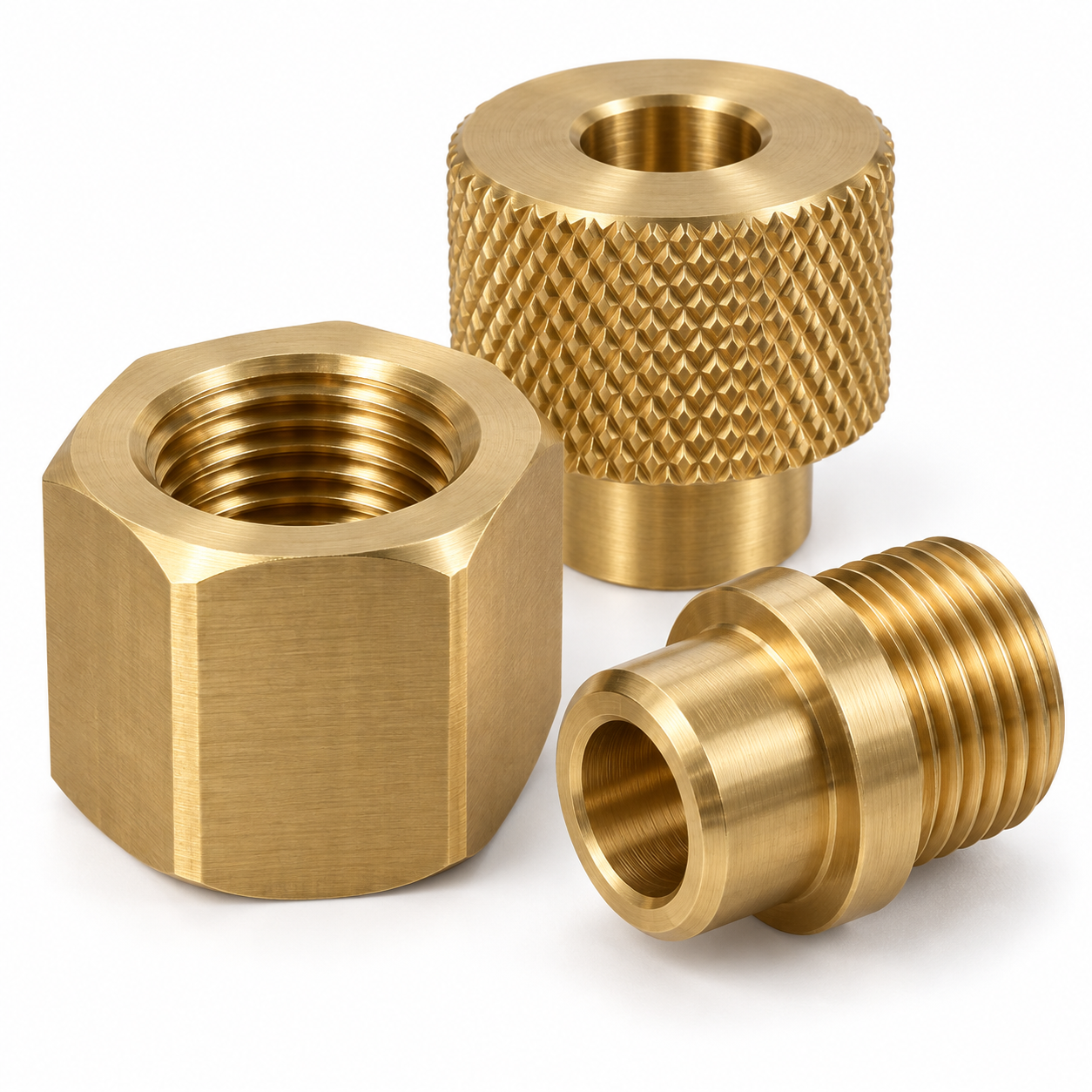 Close-up representative free-cutting brass machined components with bores, threads and finished surfaces
